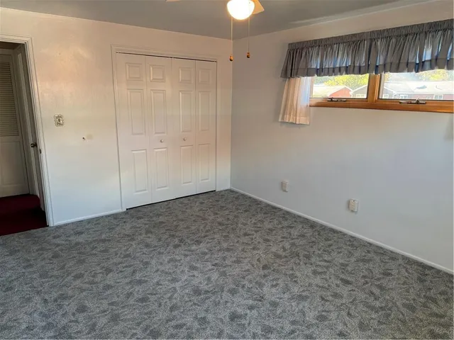 a view of an empty room and a window