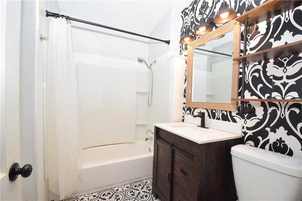 3116 Jackson Street Atlanta, GA 30354 - Photo 14 of 21 a bathroom with a sink a toilet and a mirror