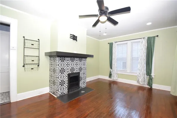 a view of empty room with wooden floor and fireplace