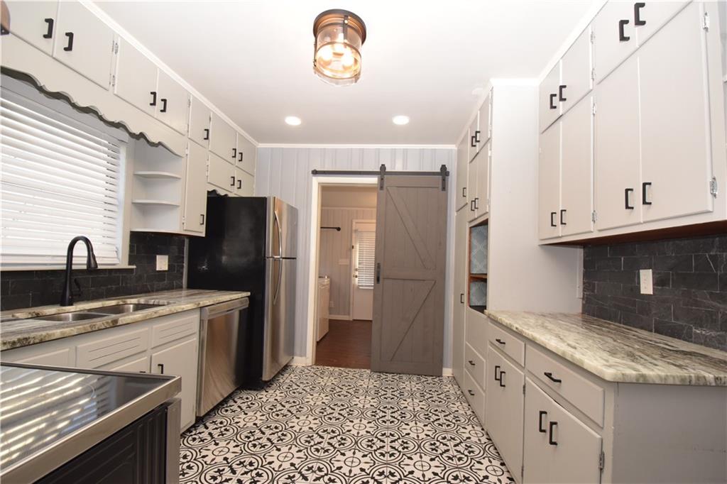 3116 Jackson Street Atlanta, GA 30354 - Photo 7 of 21 a kitchen with stainless steel appliances granite countertop a refrigerator and a stove top oven