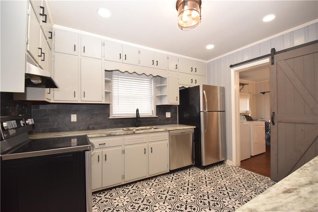3116 Jackson Street Atlanta, GA 30354 - Photo 8 of 21 a kitchen with stainless steel appliances a refrigerator sink and cabinets