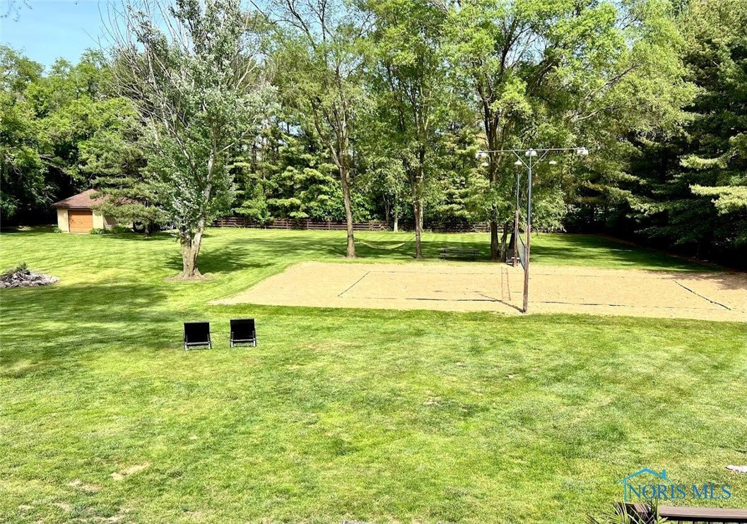 3525 Albon Road Maumee, OH 43537 - Photo 47 of 48 Hydroseeded, 230' x 270' backyard. Fully fenced in with split rail and chicken wire. 1.5 car garage/shed for storage, bonfire pit, mature trees along the majority of the property border.