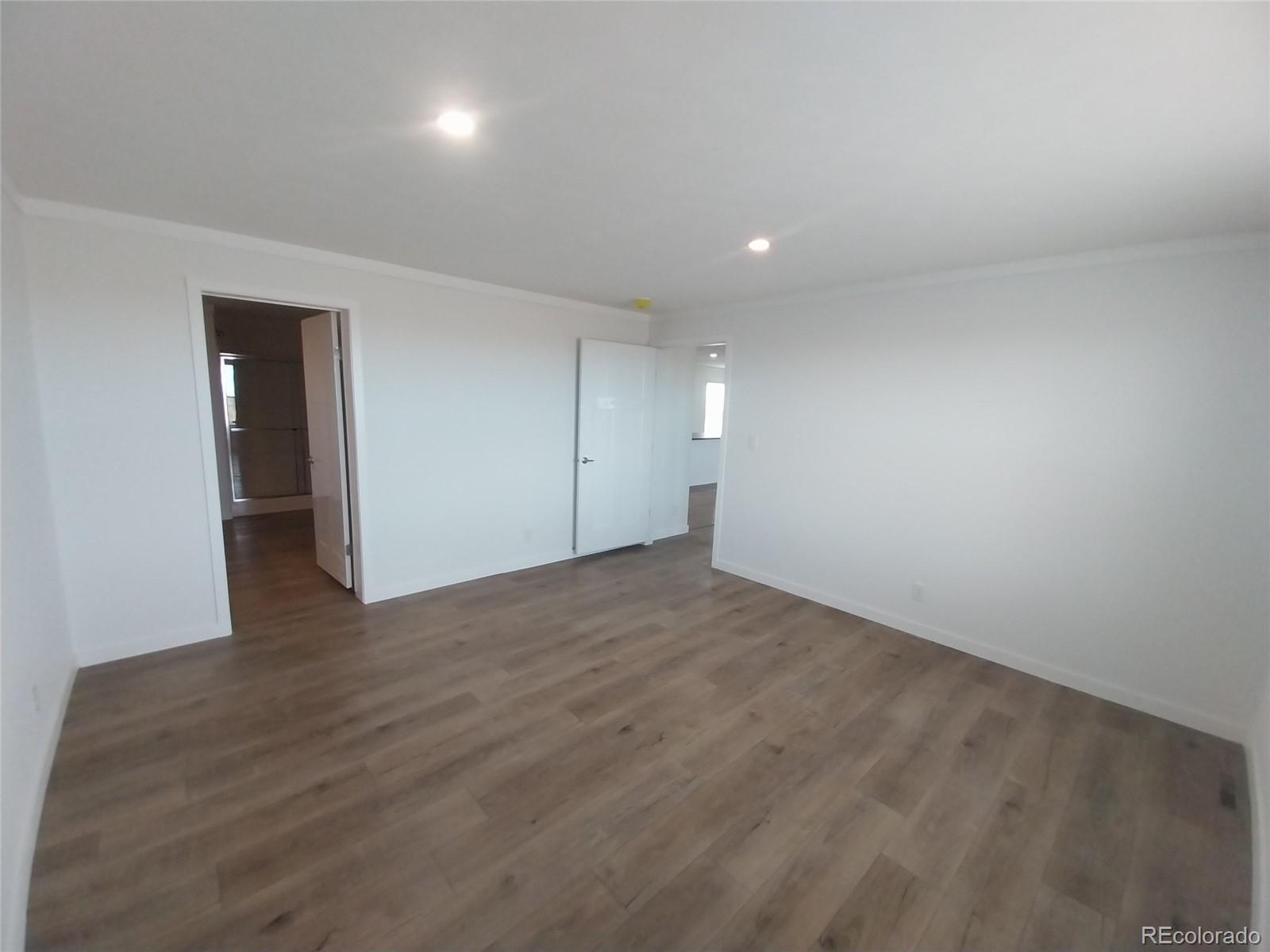 898 North Ramah Highway Yoder, CO 80864 - Photo 15 of 18 an empty room with wooden floor and windows