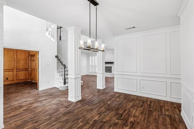 a view of empty room with wooden floor and cabinet