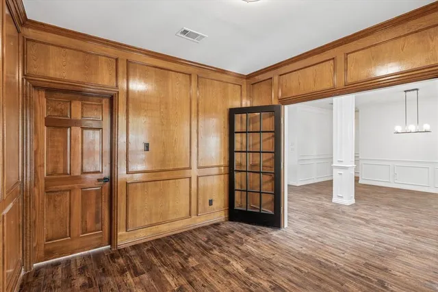 a view of empty room with wooden floor and cabinet