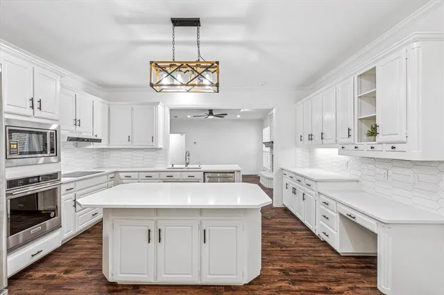 a kitchen with a stove a sink and cabinets
