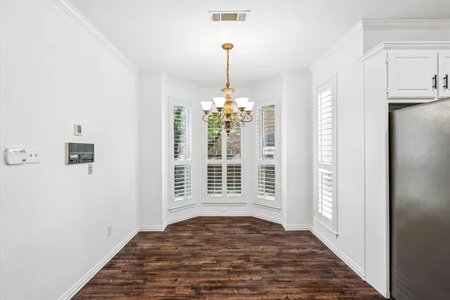 a view of empty room with window and hallway