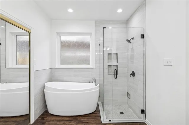 a bathroom with a bathtub and shower