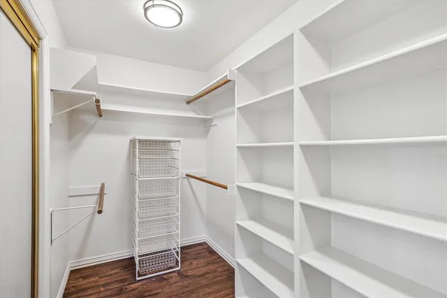 a view of walk in closet with empty racks