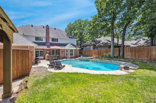 a view of a house with swimming pool and sitting area