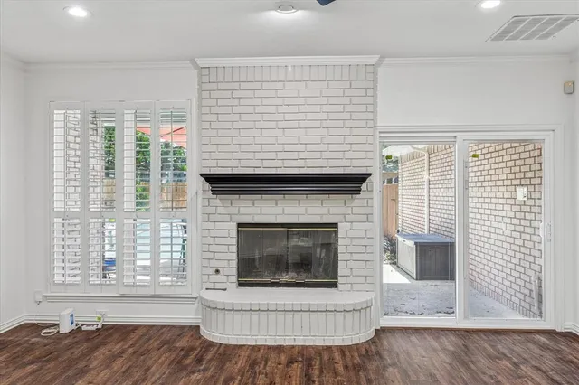 a living room with a fireplace and wooden floor