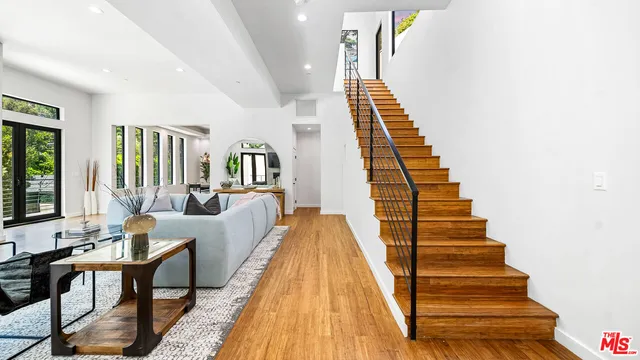 a view of entryway and hall with wooden floor
