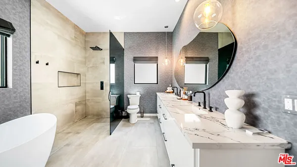 a en suite bathroom with a sink and a mirror