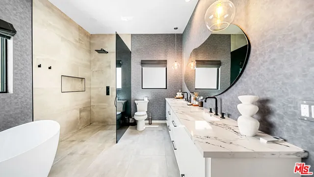 a en suite bathroom with a sink and a mirror