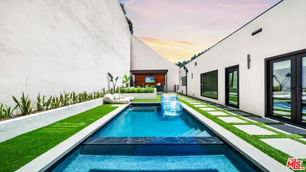 a view of swimming pool with a lounge chairs