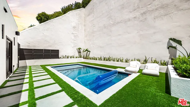 a view of swimming pool with seating space