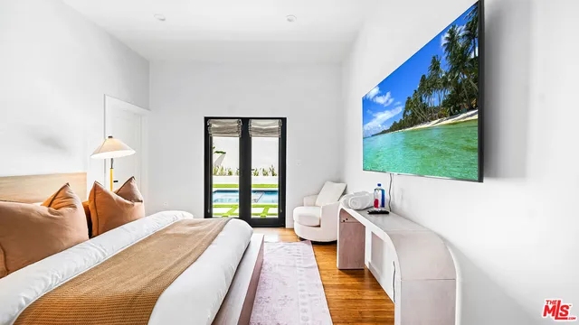 a bedroom with a bed and a large window