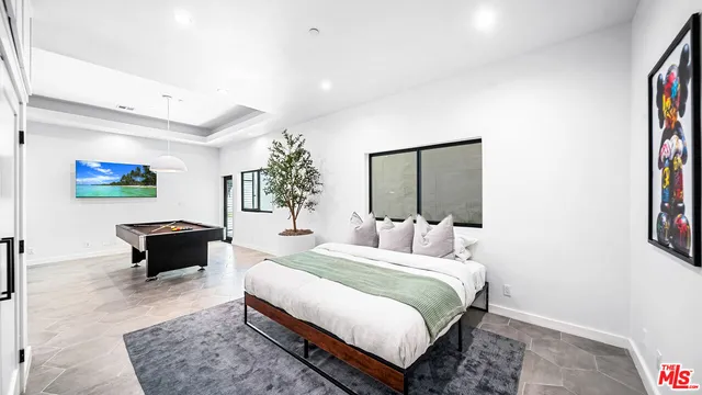 a bedroom with a bed and a couch