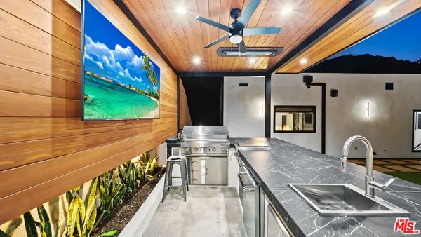 a kitchen with stainless steel appliances granite countertop a sink and a stove