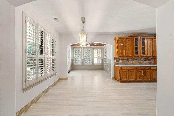 a view of kitchen with windows and refrigerator