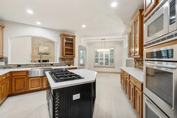 a kitchen with stainless steel appliances a stove a sink and a refrigerator