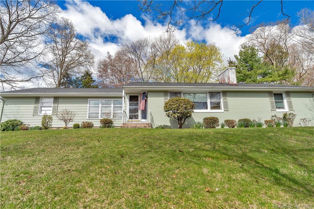 630 Lakeview Road Orange, CT 06477 - Photo 1 of 1 a front view of house with yard and green space