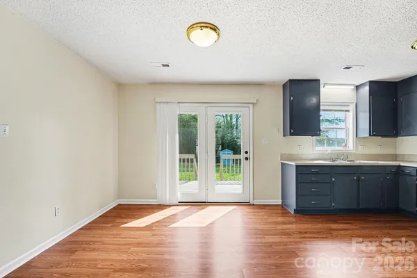 a view of a kitchen with a sink and a window