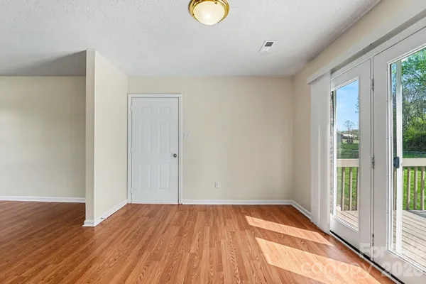 a view of a room with wooden floor and window