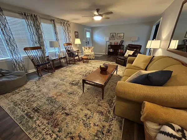 a living room with furniture and wooden floor