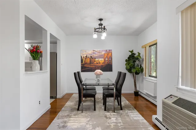 a view of a dining room with furniture window and wooden floor