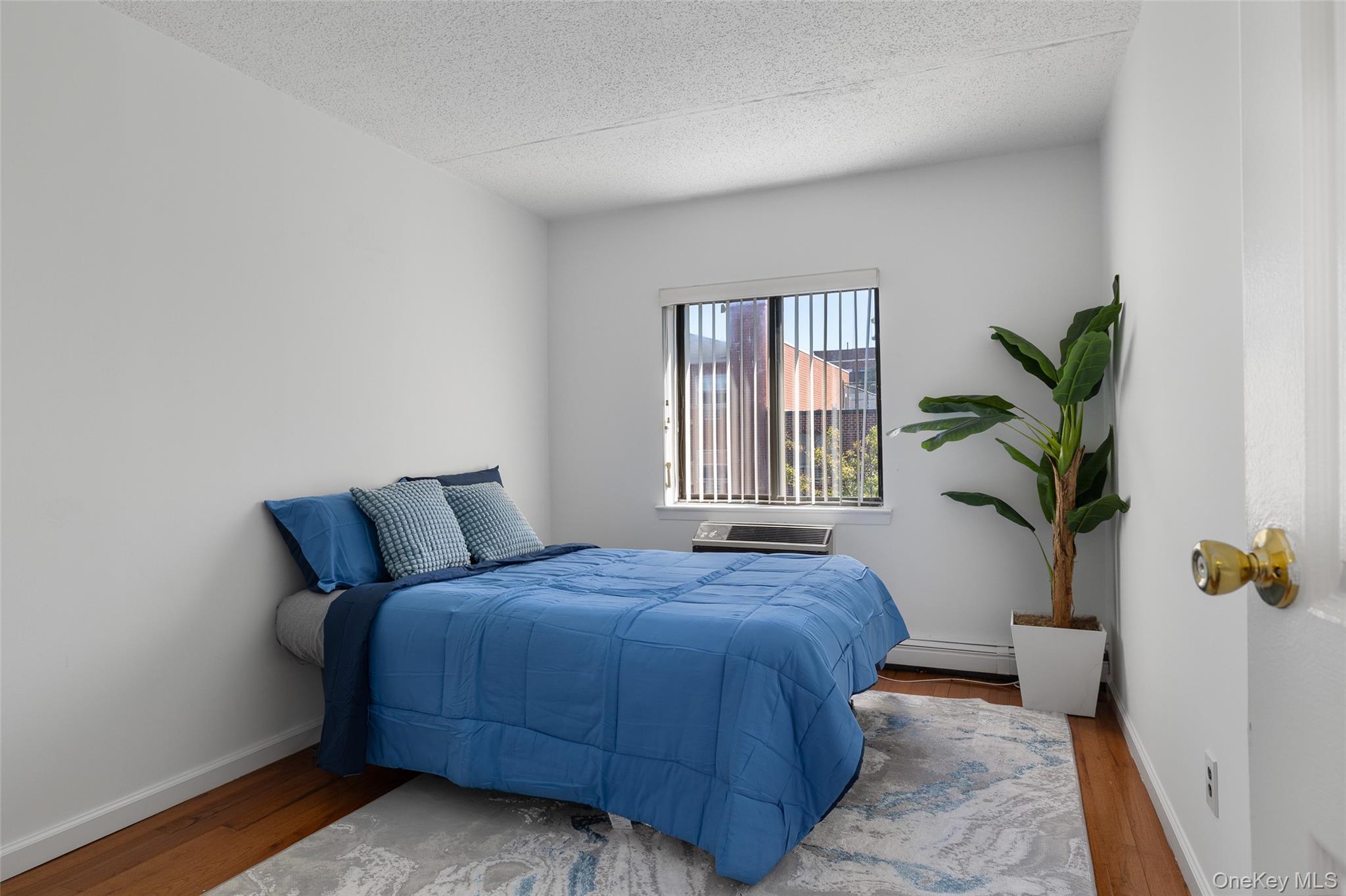 7111 Sutton Place, Unit 3 Queens, NY 11365 - Photo 17 of 27 a bedroom with a bed and a window