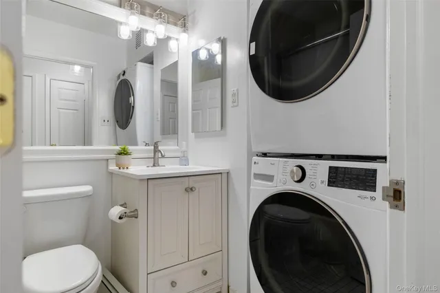 a bathroom with a toilet a sink and a mirror
