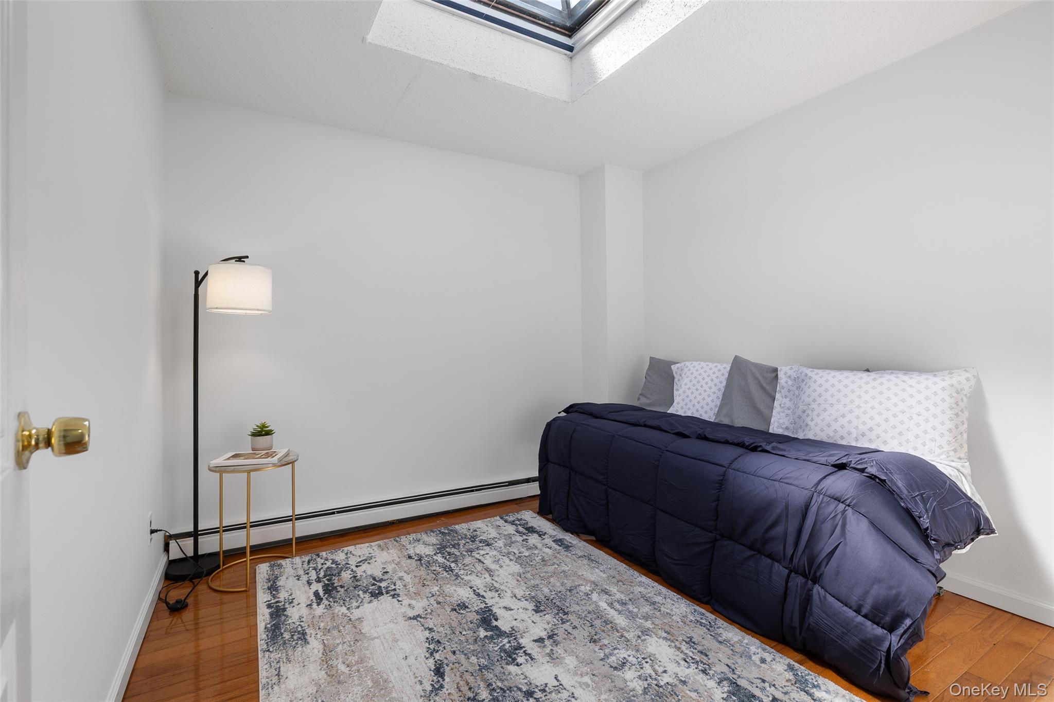 7111 Sutton Place, Unit 3 Queens, NY 11365 - Photo 20 of 27 a bedroom with a bed and a window