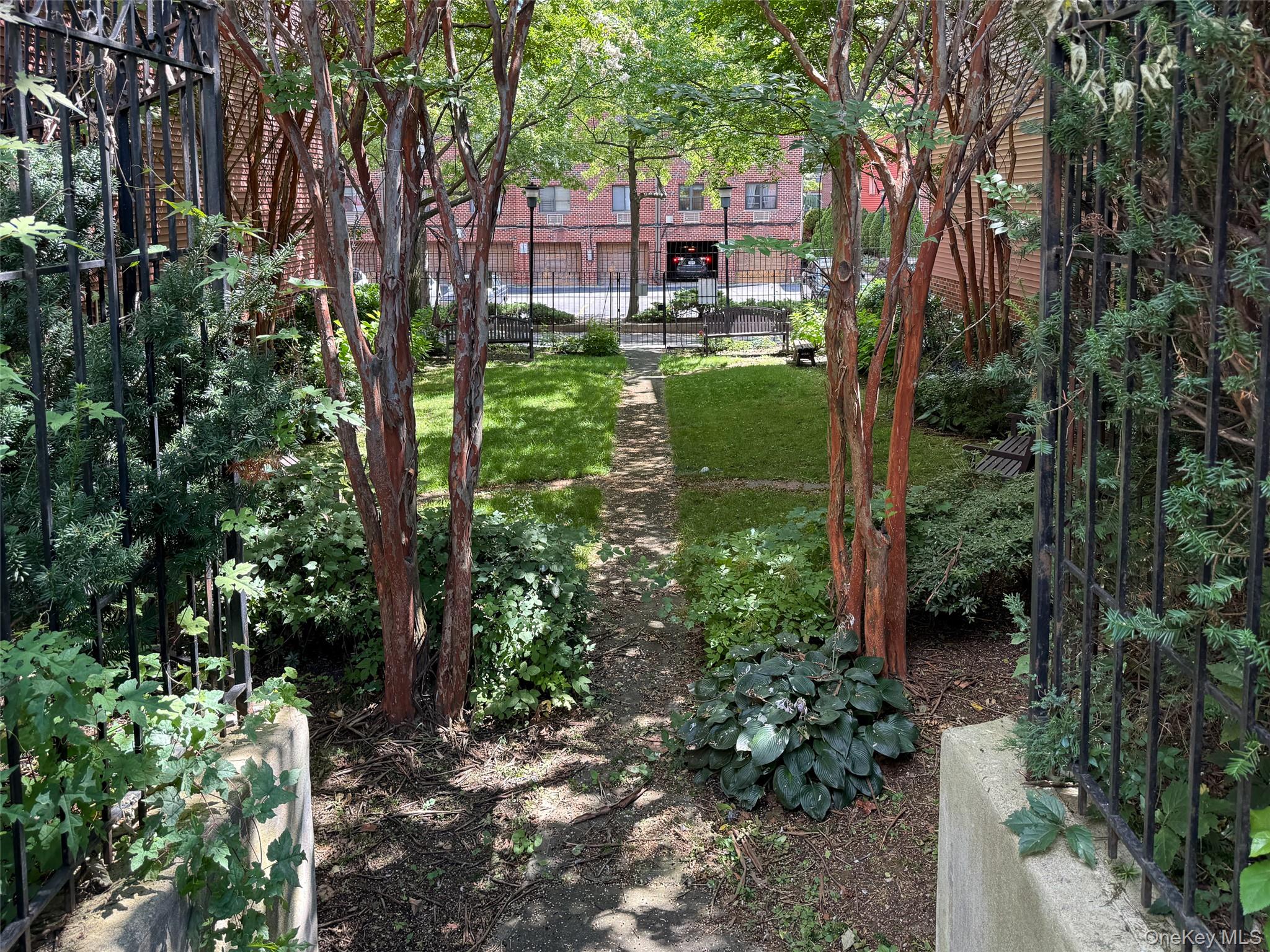 7111 Sutton Place, Unit 3 Queens, NY 11365 - Photo 26 of 27 a backyard of a house with lots of green space