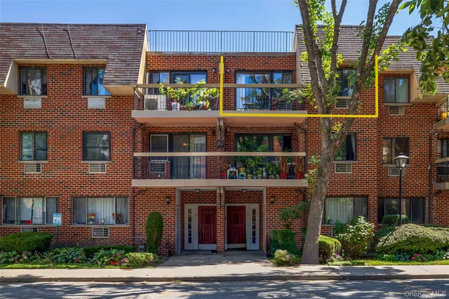 a view of a brick building next to a yard