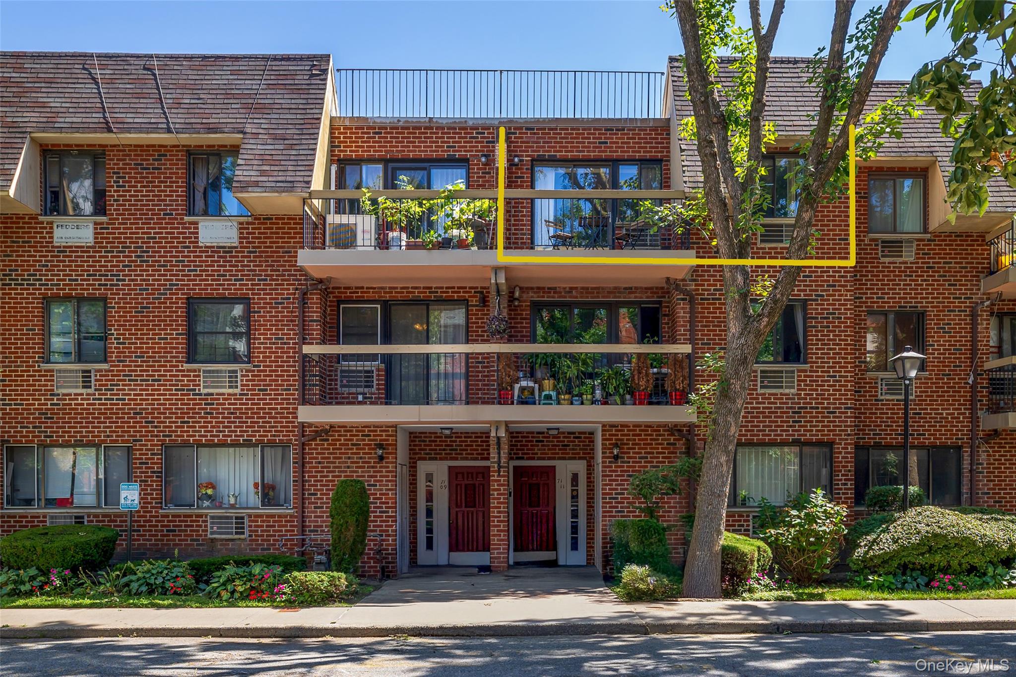7111 Sutton Place, Unit 3 Queens, NY 11365 - Photo 4 of 27 a view of a brick building next to a yard