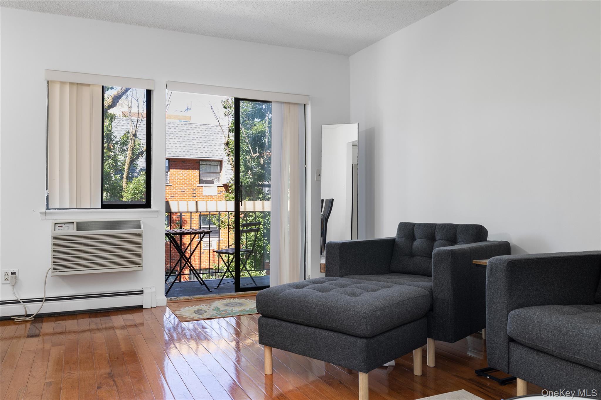 7111 Sutton Place, Unit 3 Queens, NY 11365 - Photo 7 of 27 a living room with furniture and a window