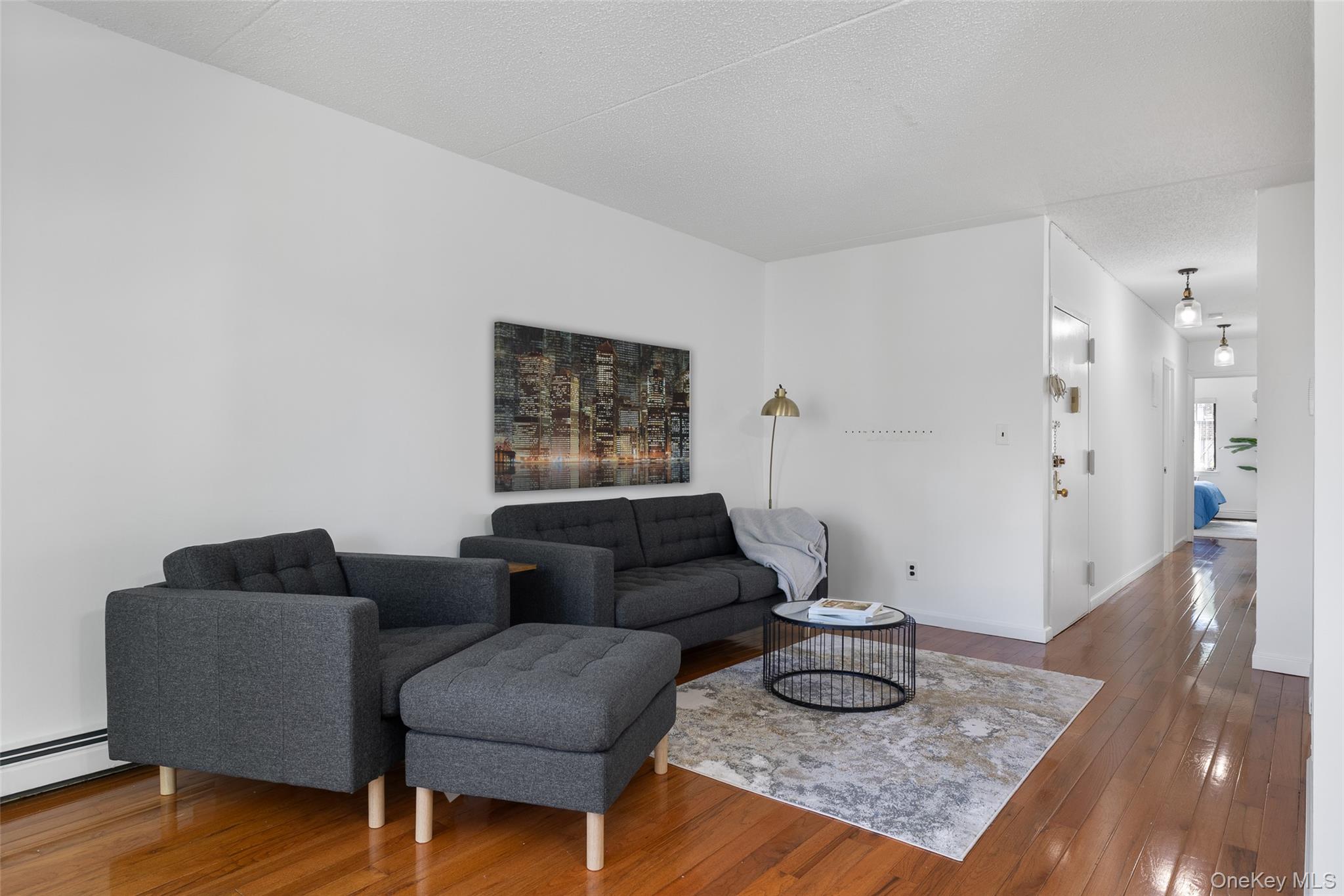 7111 Sutton Place, Unit 3 Queens, NY 11365 - Photo 10 of 27 a living room with furniture and a wooden floor