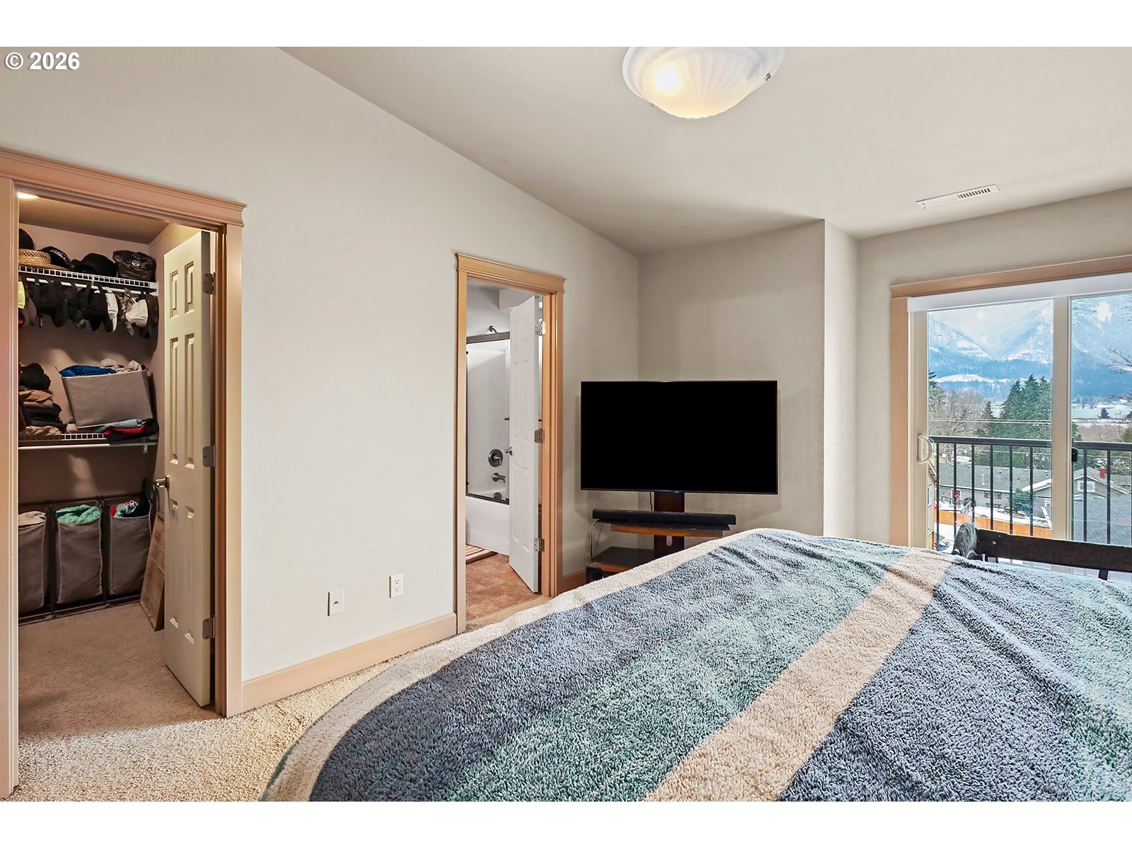 41 Lasher Street, Unit C4 Stevenson, WA 98648 - Photo 27 of 48 a bedroom with a bed and a flat screen tv