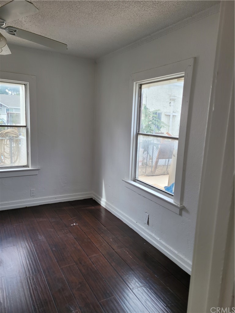 3077 Lemon Street Riverside, CA 92501 - Photo 4 of 20 a view of an empty room with wooden floor and a window