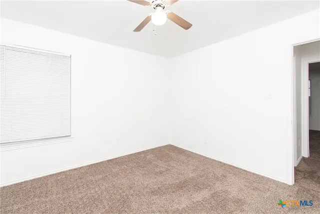 a view of a room with a ceiling fan