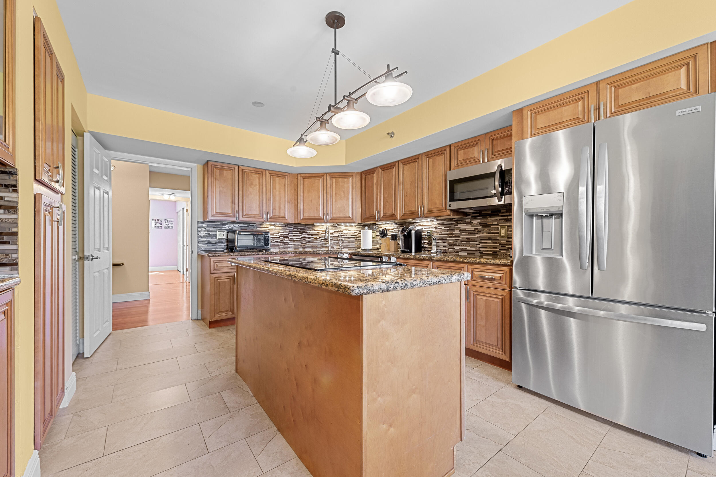 7209 Promenade Drive, Unit 201 Boca Raton, FL 33433 - Photo 16 of 41 a kitchen with stainless steel appliances granite countertop a refrigerator a oven a sink and dishwasher