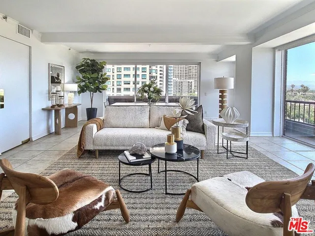 a dining hall with stainless steel appliances granite countertop furniture and a kitchen view