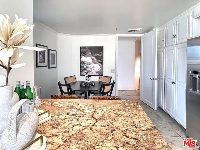 a kitchen with a sink dishwasher a stove top oven a dining table and chairs