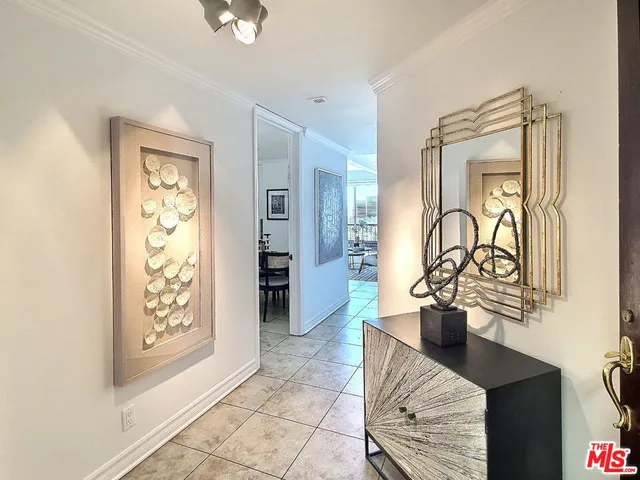 a hallway with a view of living room with furniture