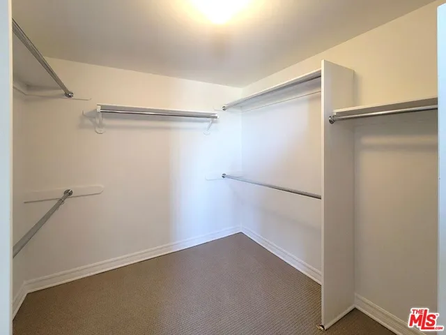 a bedroom with bed and a window