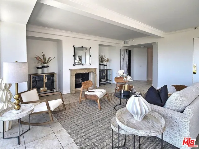 a living room with furniture a large window and a fireplace