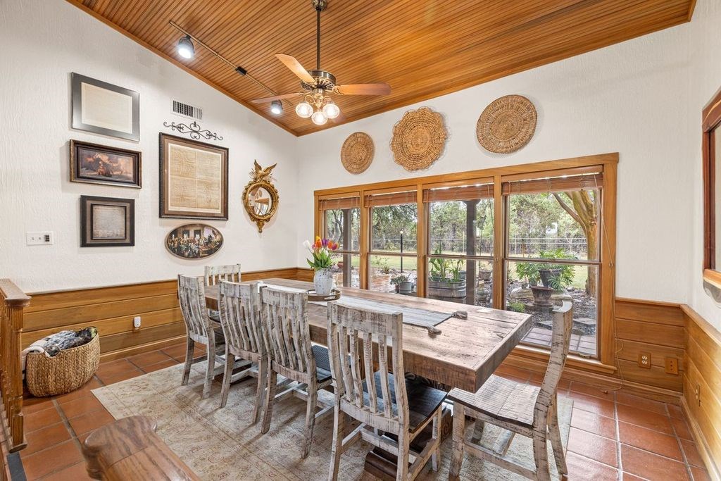257 Encino Loop Kerrville, TX 78028 - Photo 11 of 92 a view of a dining room with furniture chandelier and a large window