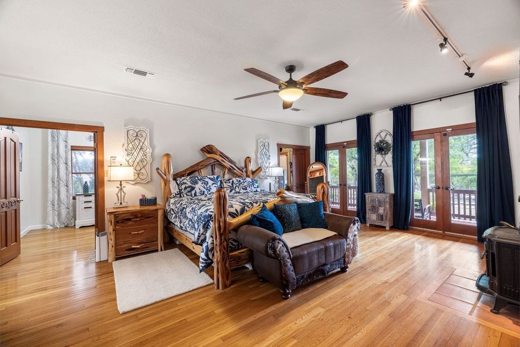 257 Encino Loop Kerrville, TX 78028 - Photo 12 of 92 a bedroom with furniture and a wooden floor