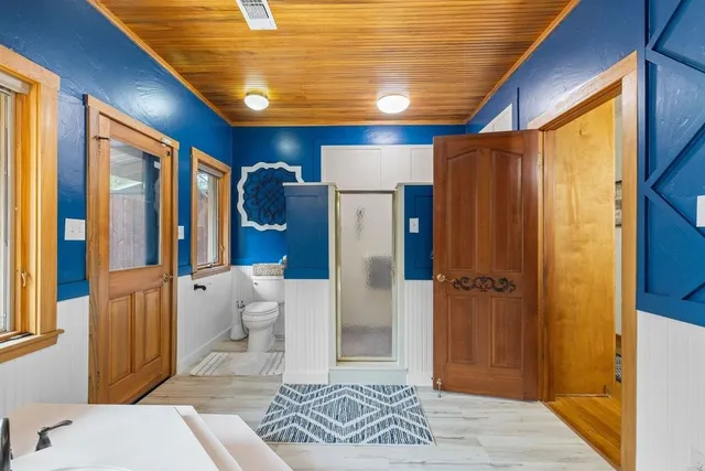 a utility room with fridge dryer and washer
